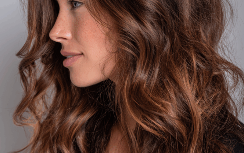 Dark hair with balayage highlights featuring caramel and honey tones for natural dimensional color